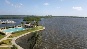 A waterfront hotel with a swimming pool, a covered patio, and a view of the water. - Million Dollar View  Bay Sunrises & Gulf Sunsets-Feb and March open 2025 (Sarasota)