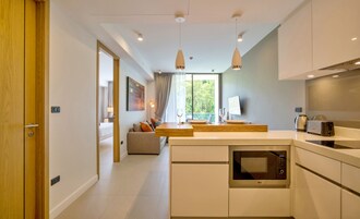 1 Bedroom Superior with Tropical View | Private kitchen | Fridge, microwave, stovetop, cookware/dishes/utensils