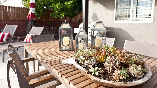 A wooden table with a planter of succulents and two lanterns. - LAST MINUTE SPECIAL! WALK TO DISNEY & CONVENTION CENTER! Private heatedpool (Anaheim)