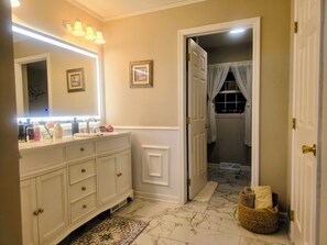 A bathroom with a vanity, mirror, and toiletries. - Surrounded by orchards & vineyards, we are in the heart of wine country (Westfield)