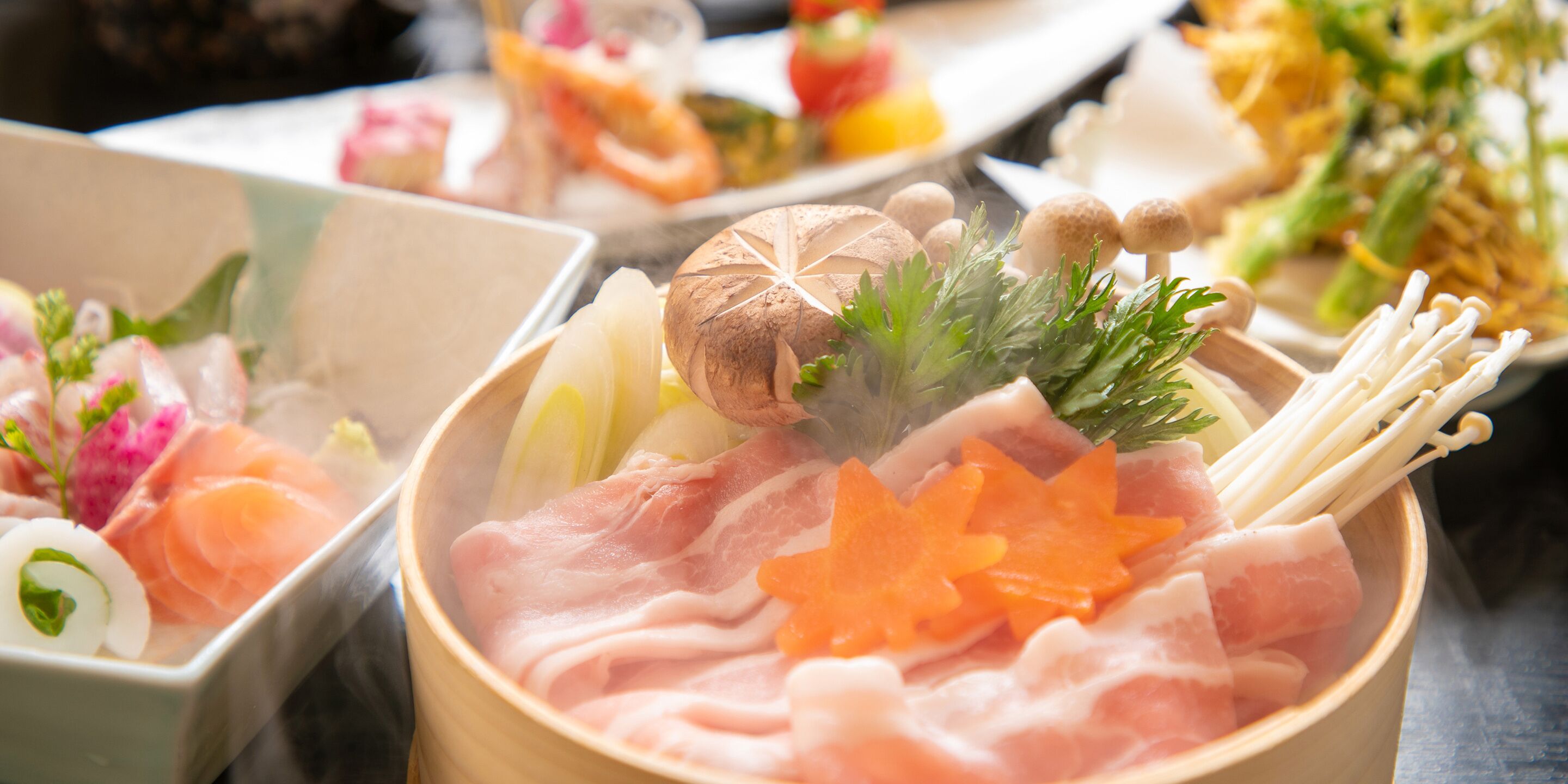A variety of dishes including sashimi, vegetables, and mushrooms in a wooden bowl.
