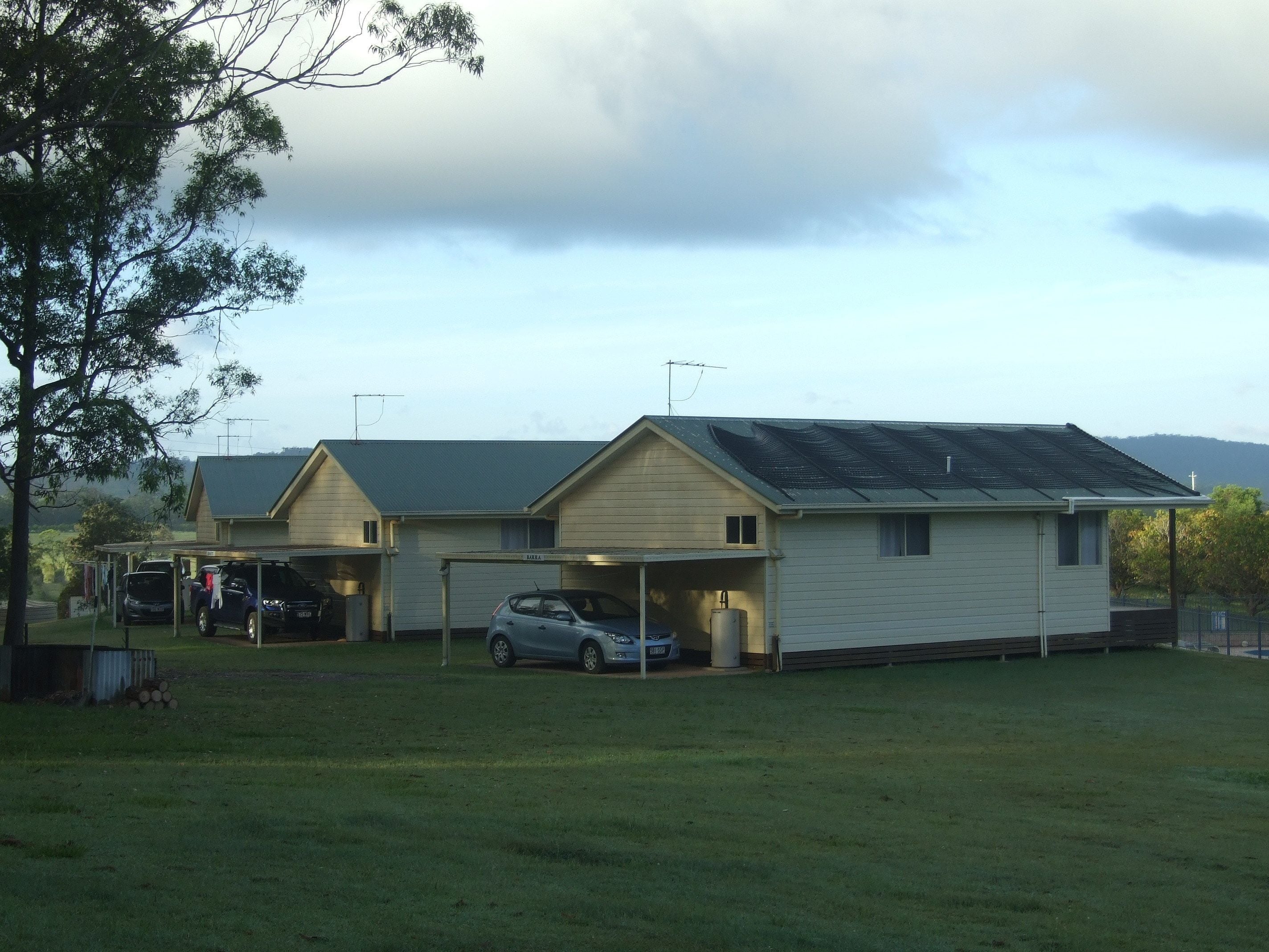 A two-story building with a garage and a covered parking area.
