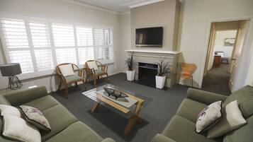 Luxury Cottage, 2 Bedrooms, Garden View | Living area | 55-cm flat-screen TV with satellite channels, TV, DVD player