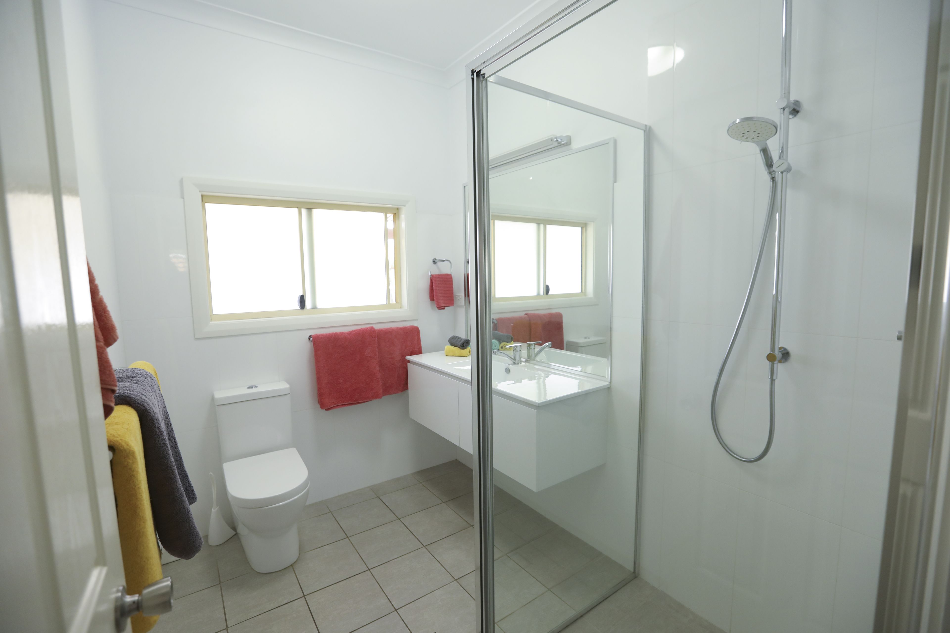 A bathroom with a toilet, sink, and shower.