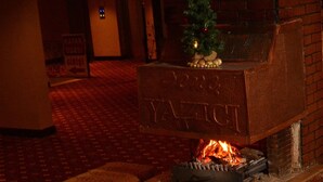 A fireplace with a Christmas tree and a sign reading "KAYAK ODAS GIRLS". - Genc Yazici Hotel Uludag (Bursa)