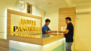 A hotel reception desk with a sign reading "HOTEL PANORAMA".