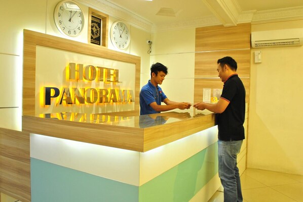 A hotel reception desk with a sign reading "HOTEL PANORAMA". - Hotel Panorama (Tanjung Pinang)