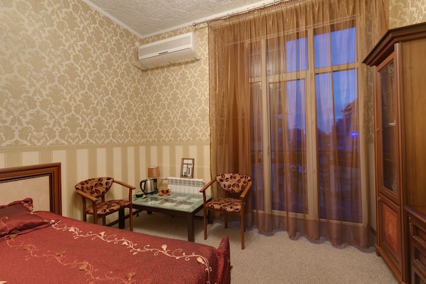 Desk, iron/ironing board, bed sheets