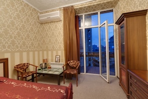 Desk, iron/ironing board, bed sheets