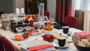 A breakfast buffet with various food items and condiments. - B&B Scheldekant (Oudenaarde)