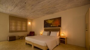 A bedroom with a wooden bed, bedside tables with lamps, a large painting on the wall, and a wooden ceiling. - Epic Unawatuna (Unawatuna)