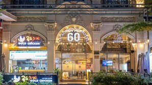 Ein Hotel mit einer auffälligen „60“-Beschilderung, einem Restaurant namens „Gold Chicken“ und einem „Massage & Spa“-Service.