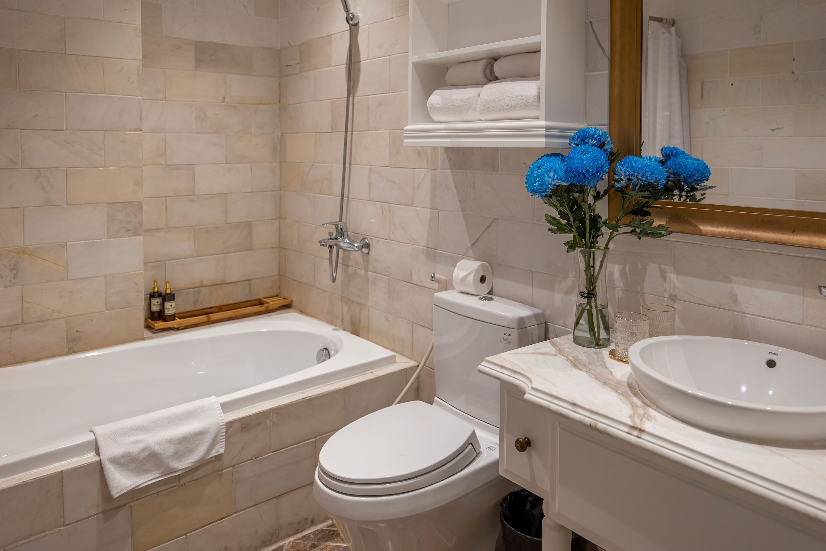 A modern bathroom with a bathtub, toilet, and sink.