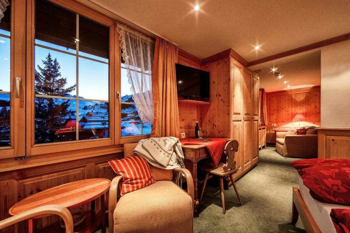 A cozy room with a wooden interior, a dining area, and a bed.