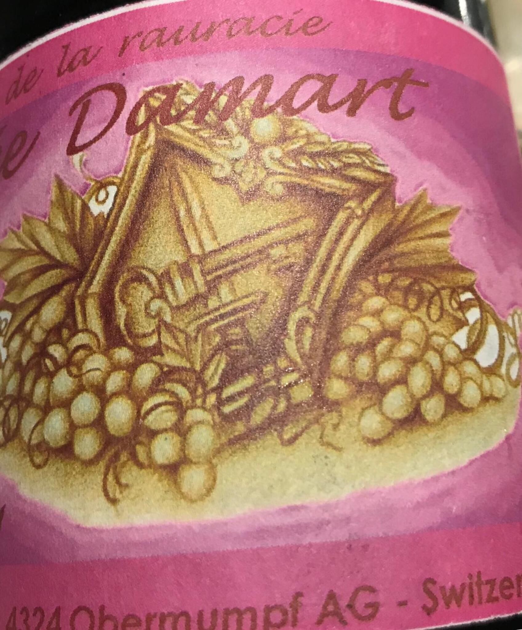 A label with a grape cluster and a wine bottle illustration, indicating a wine product.
