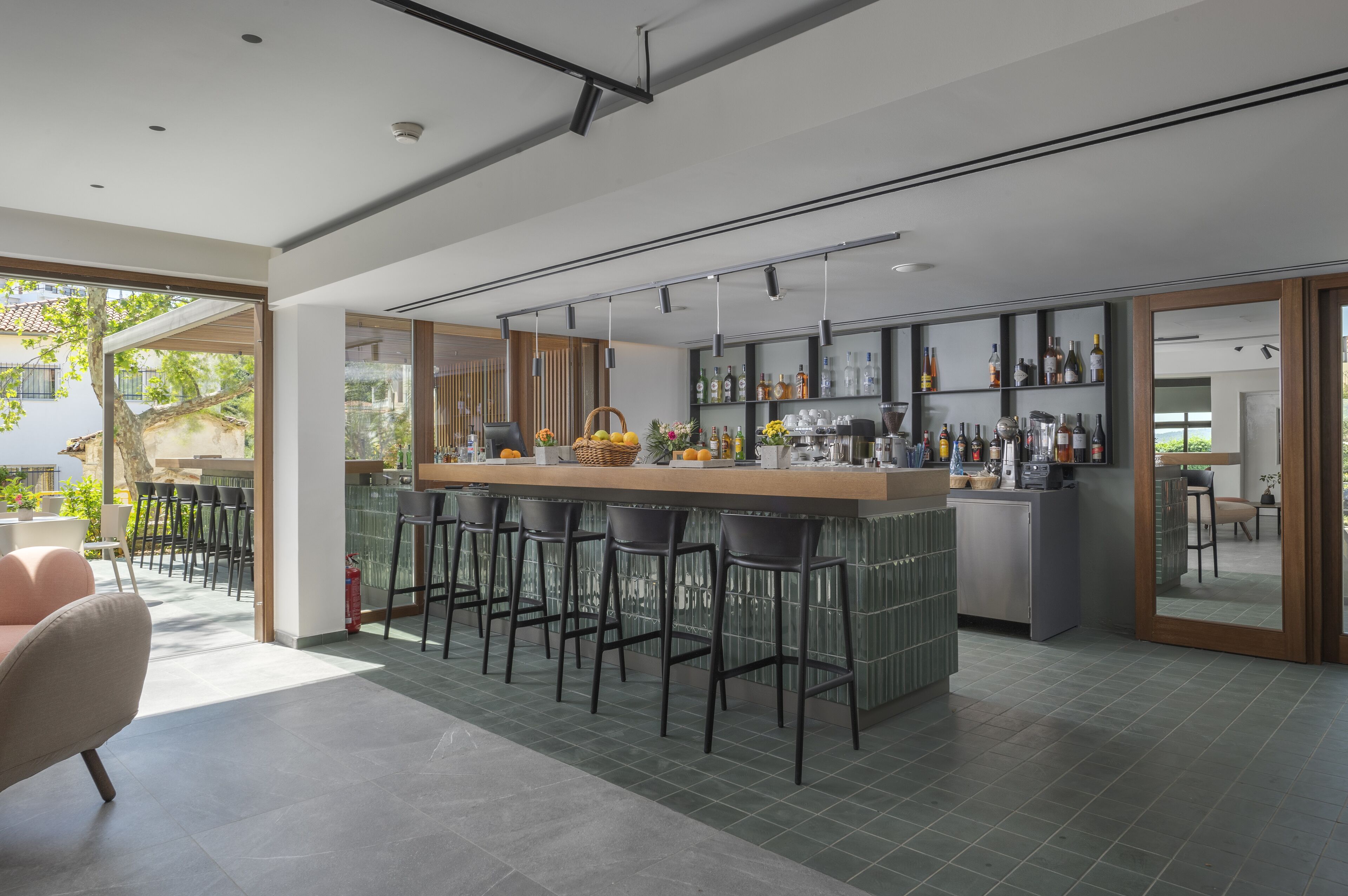 A modern kitchen with a central island, bar stools, and a variety of kitchen appliances.