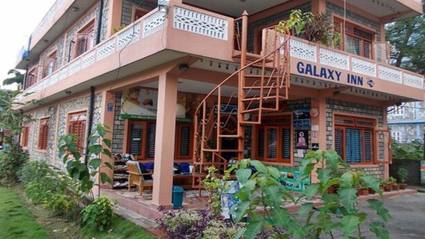 A two-story building with a balcony and a sign that reads "GALAXY INN". - Galaxy Inn Guest House (Pokhara)