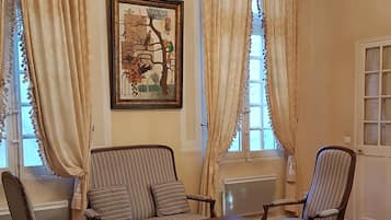 Superior Room, 1 Queen Bed, Kitchenette | Living area | Flat-screen TV