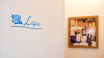 A wall with a logo and a framed picture of a vehicle.