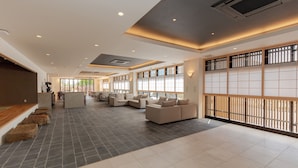 A spacious lobby with a mix of seating areas, a reception desk, and large windows providing natural light. - Ariston Hotel Kyoto Jujo (Kyoto)
