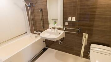 A modern bathroom with a bathtub, sink, and toilet.