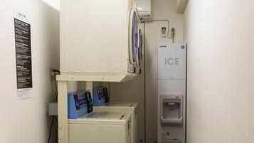 A narrow corridor with a microwave, a water dispenser, and a refrigerator labeled "ICE".
