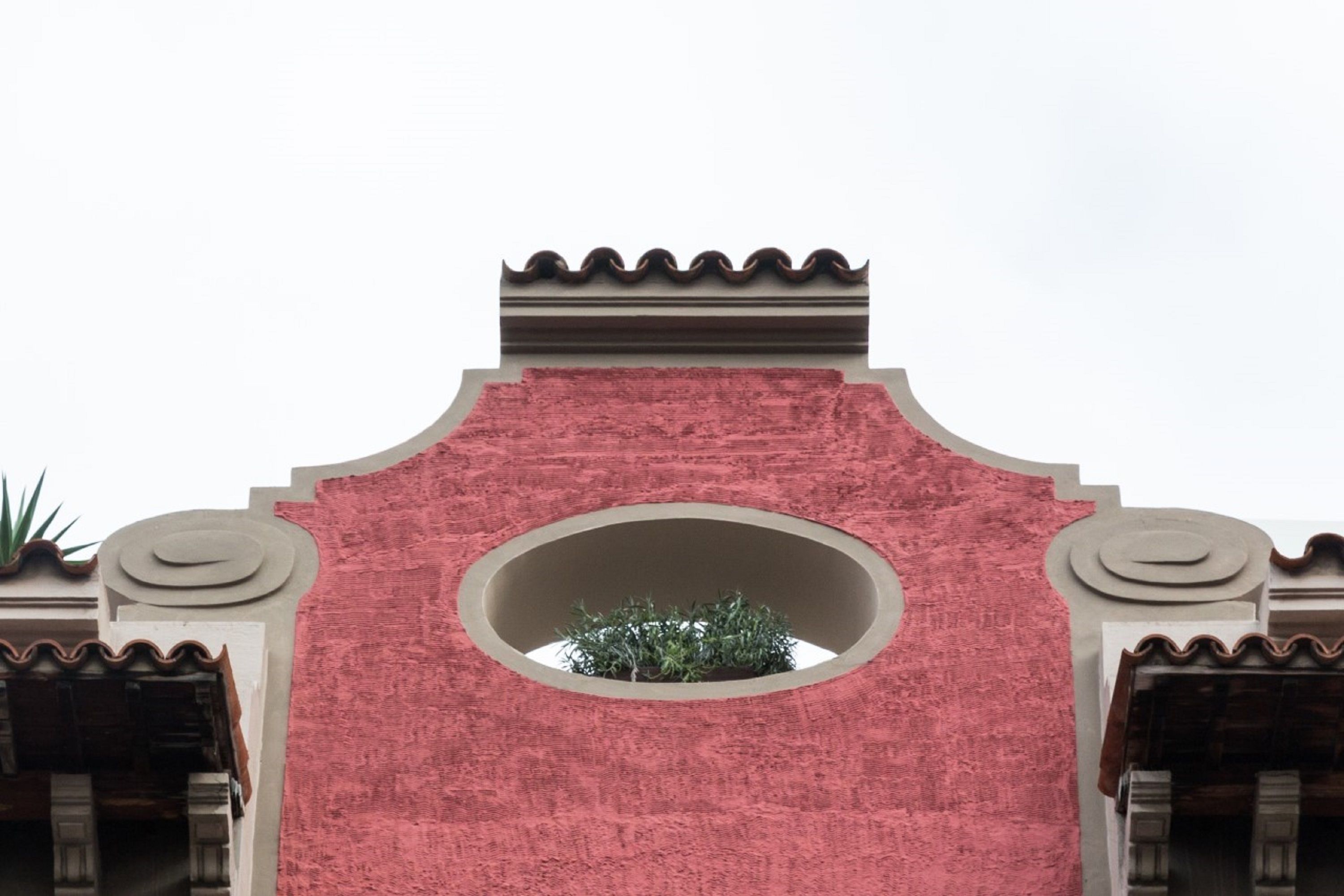 A building facade with a central circular window and decorative elements.
