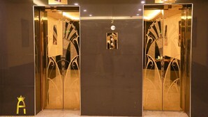 A set of elevator doors with ornate designs and a digital display. - Amman Palace Hotel (Amman)