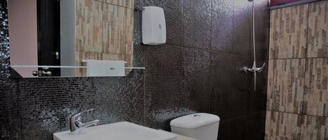 A modern bathroom with a rectangular sink, a toilet, and a shower.