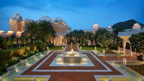 A grand building with multiple domes and a central fountain.
