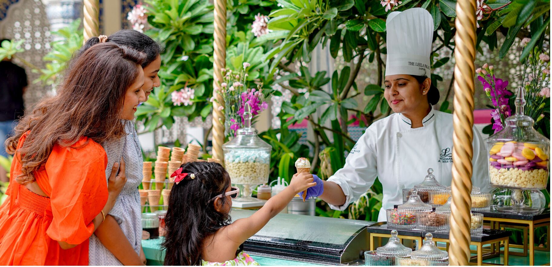 A food vendor with a variety of desserts and snacks, including ice cream cones and candy.