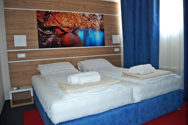 Desk, iron/ironing board, bed sheets