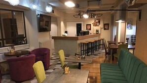 A modern interior with a bar area, seating, and a counter. - Guest House Vida (Belgrade)