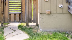 A wooden gate leading to a building with climbing holds on the wall. - 1936 Keystone Cottage - Family Friendly (Boise)