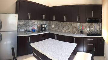 Full-sized fridge, microwave, stovetop, coffee/tea maker