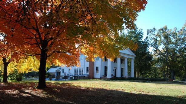 A white building with columns, surrounded by trees with autumn leaves. - The Colonels B&B and Inn (Athens)