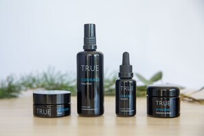 Four skincare products from the brand TRUE, including face mist, face oil, balm, and exfoliate & mask. - Release Wanaka - Bullock Creek Chalet (Wanaka)