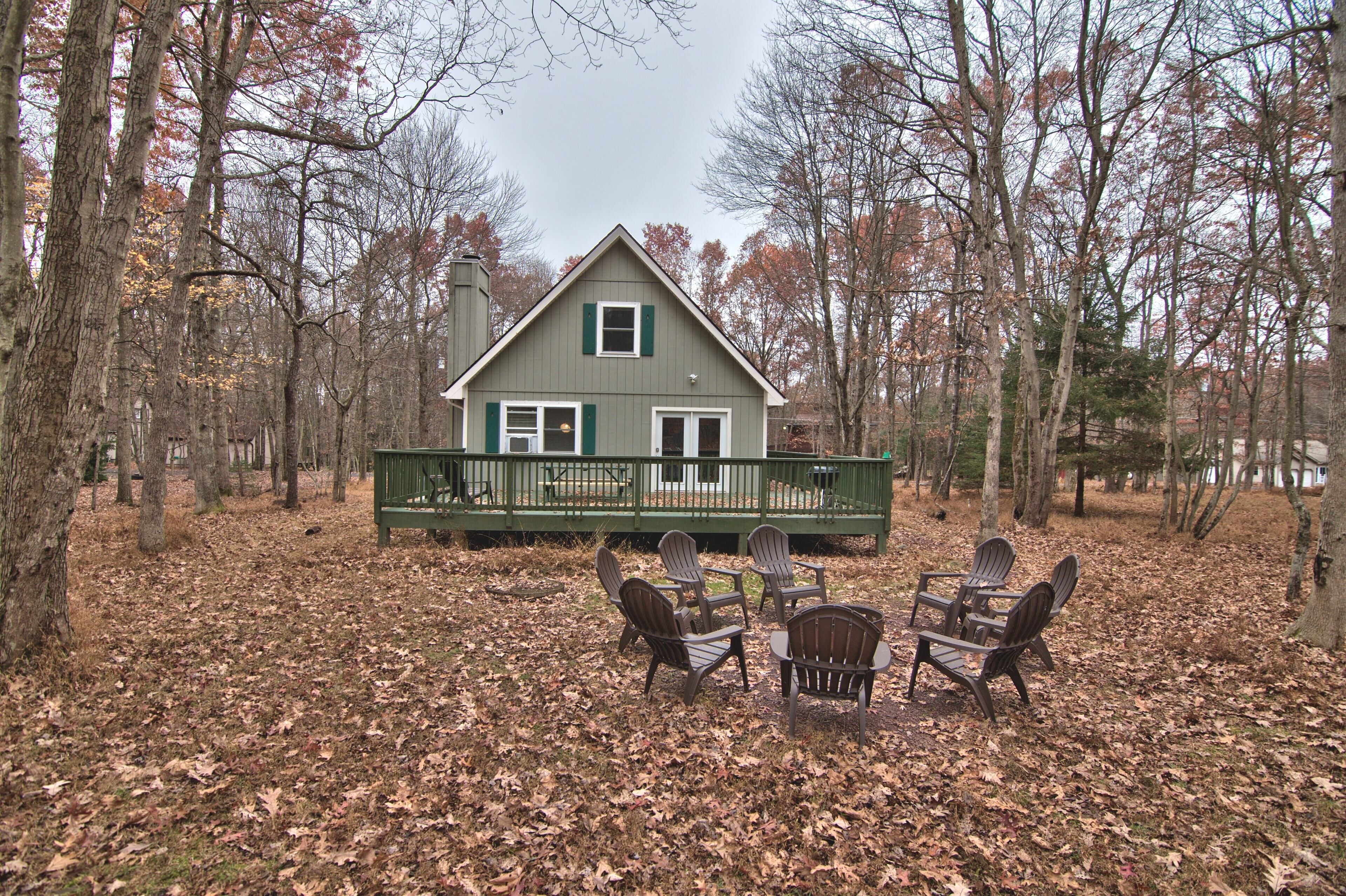 A cabin with a porch and outdoor seating.