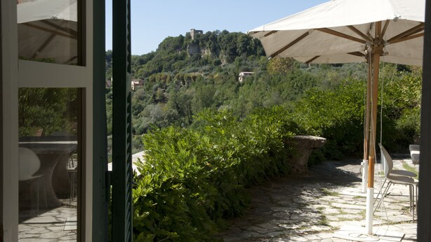 A stone pathway leading to outdoor seating with a view of a hillside. - Renaissance Villa of the Aqueduct 1hr from Rome. Lazio-Umbria border  (Orte)