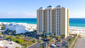 A high-rise hotel with multiple balconies overlooking a beach. - Gulf Front Condo with Luxury Furnishings and Beach Chairs  (Pensacola Beach)
