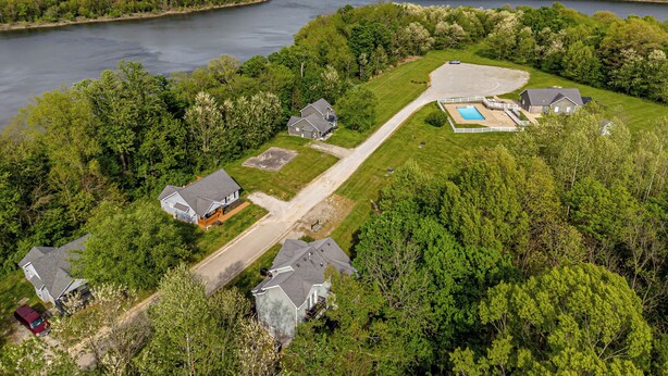 An aerial view of a residential area with houses, a swimming pool, and a river. - "On the Rocks"  Bourbon Trail Getaway (Taylorsville)