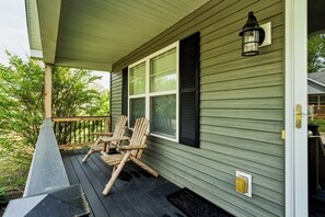 A porch with two wooden chairs, a wooden railing, and a window with shutters. - "On the Rocks"  Bourbon Trail Getaway (Taylorsville)