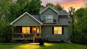 A two-story house with a front porch, a balcony, and a garage. - "On the Rocks"  Bourbon Trail Getaway (Taylorsville)