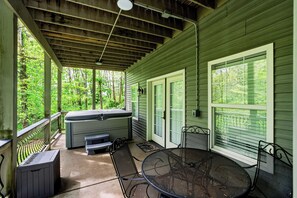 A covered porch with a hot tub, seating, and a table. - "On the Rocks"  Bourbon Trail Getaway (Taylorsville)