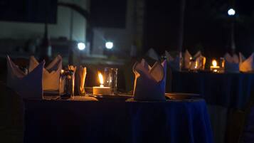 A table set for dining with candles and napkins.