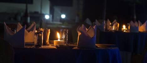 A table set for dining with candles and napkins.