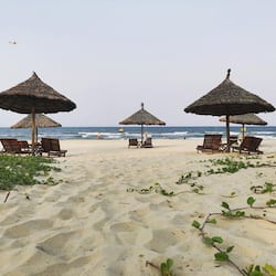 On the beach, white sand, sun-loungers, beach umbrellas