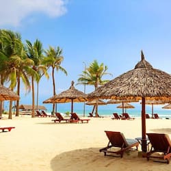 On the beach, white sand, sun-loungers, beach umbrellas