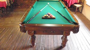 A pool table in a room with brick walls and wooden flooring. - Hotel U Branky (Stribro)