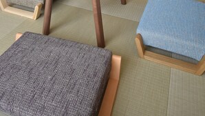 A compact room with a bed, a small round table, and a seating area with cushions. - ieLIFE Resort HIGASHIYAMA (Kyoto)